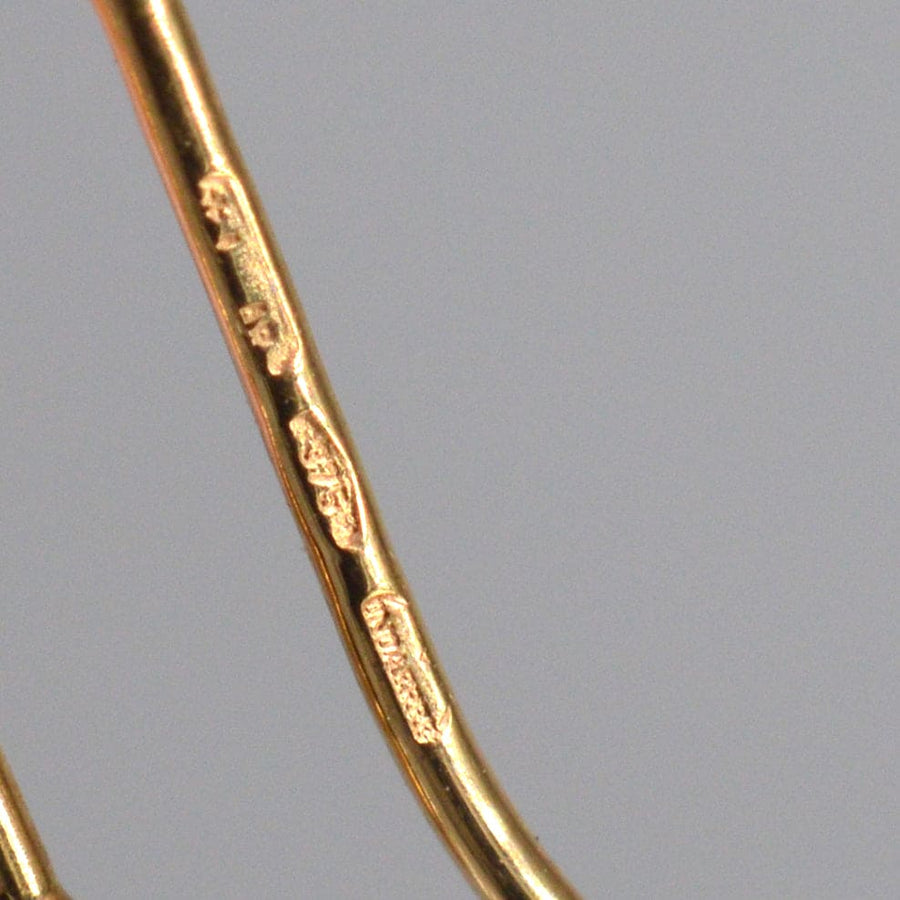 Close-up of hallmarks on 1940s 9ct gold earrings, showcasing authentic vintage details.