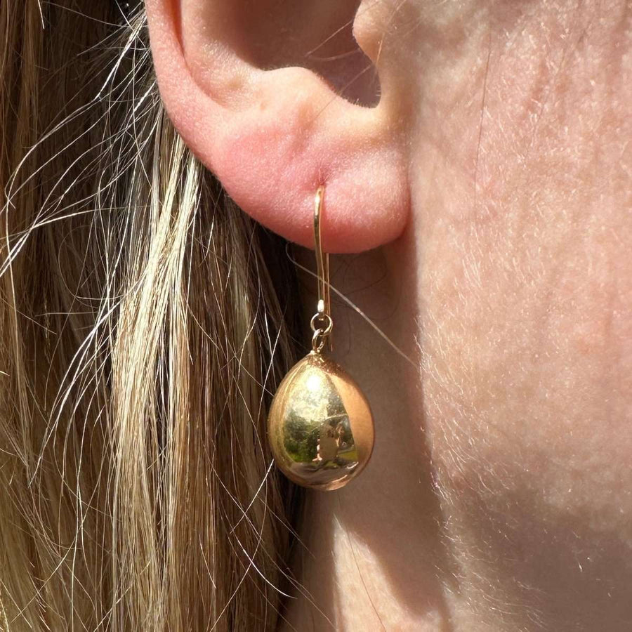 1940s 9ct gold earrings with large teardrop design, worn elegantly, showcasing vintage mid-century style.