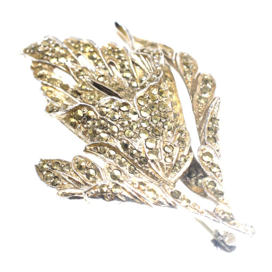 1940s chrome and marcasite floral brooch with intricate leaf design, sparkling like rose cut diamonds.