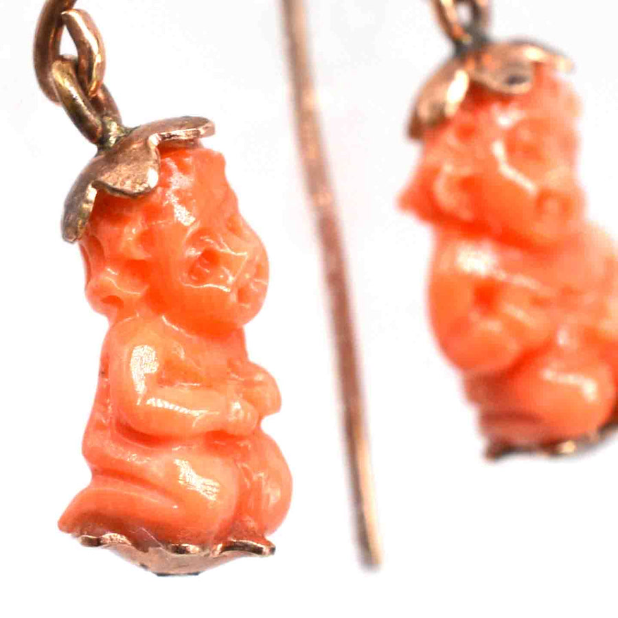 Georgian 12ct gold earrings featuring carved coral cupids, symbolizing love and protection, from the 1820s-1840s.
