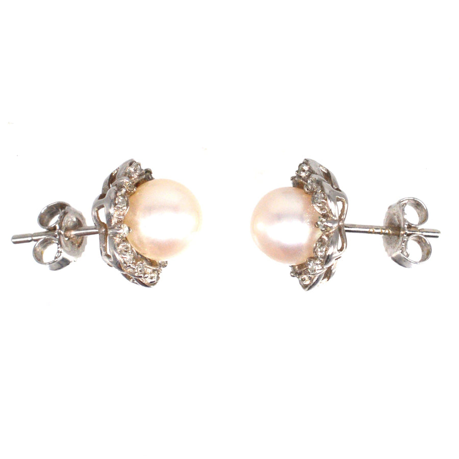 Mid Century 9ct white gold pearl and diamond star cluster earrings, showcasing vintage elegance and timeless charm.