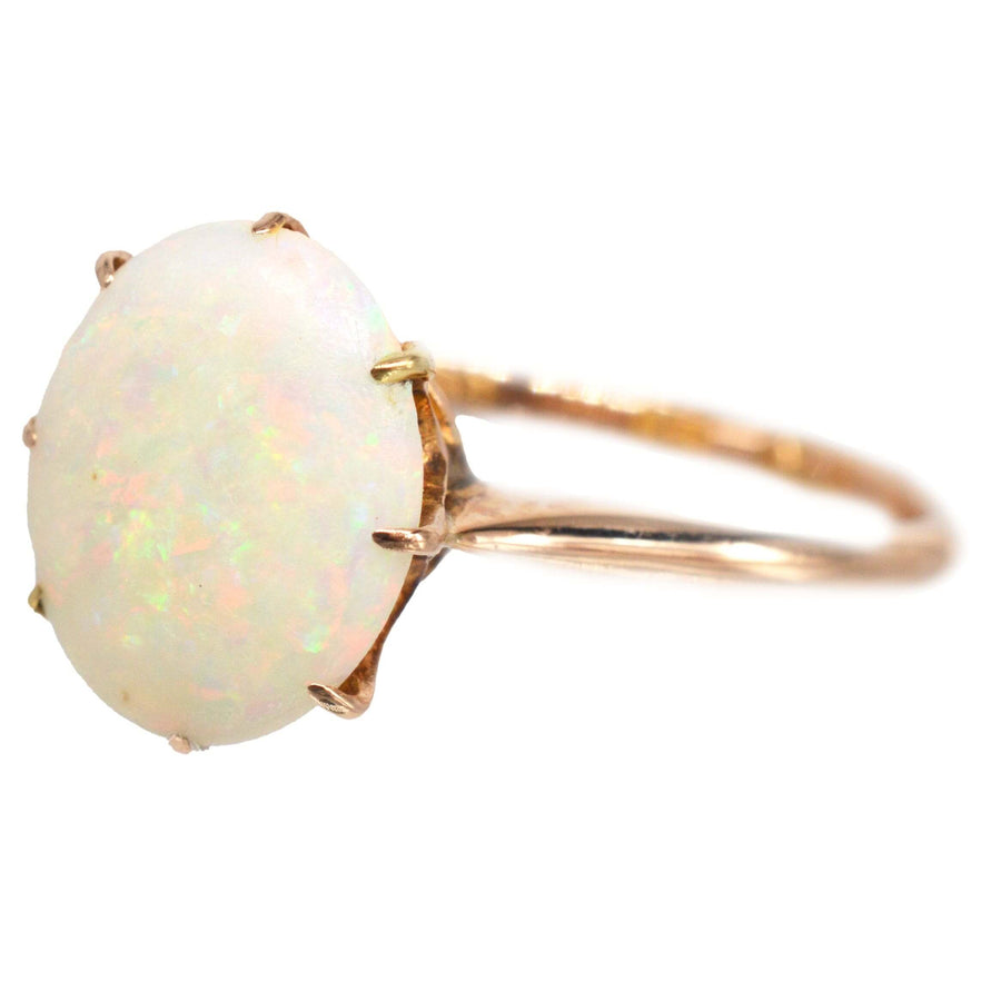 Art Deco 18ct gold ring featuring a natural white opal with vibrant red and green hues, showcasing vintage elegance.