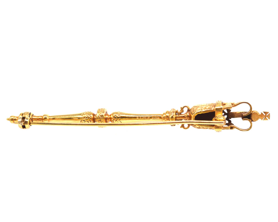 Vintage 9ct gold royal mace brooch with rubies, symbol of British authority and tradition, beautifully crafted.