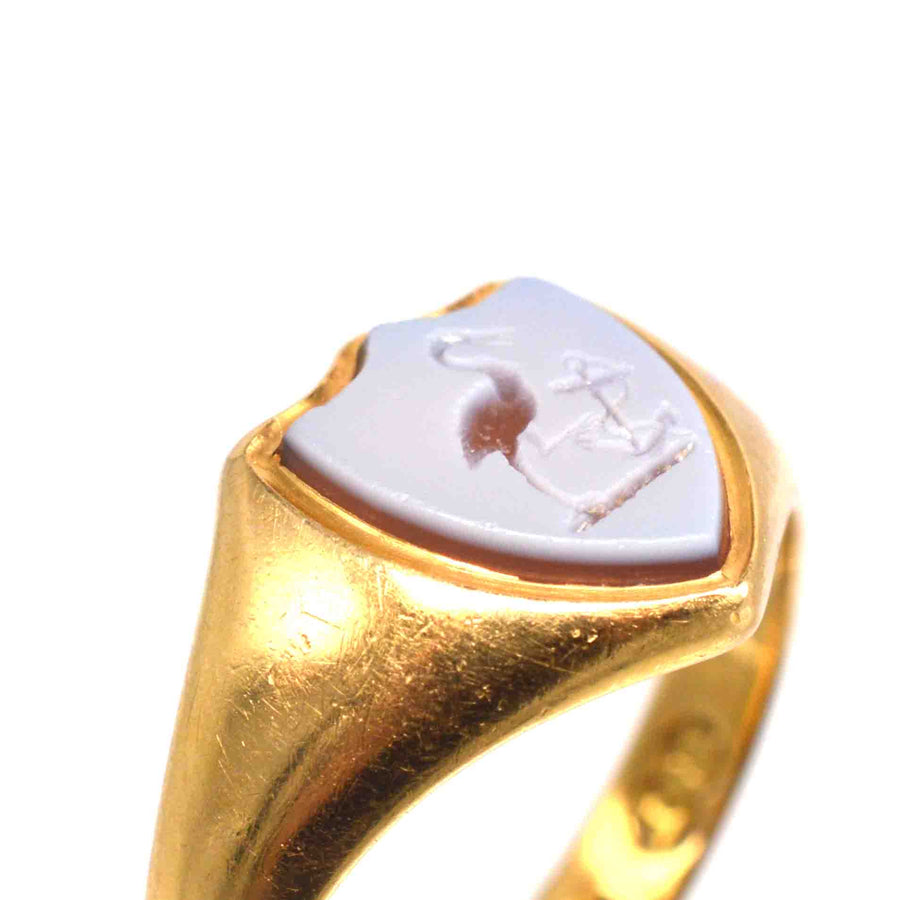 Victorian 18ct gold signet ring with carnelian engraving of a stork and anchor motif, representing elegant historical craftsmanship.