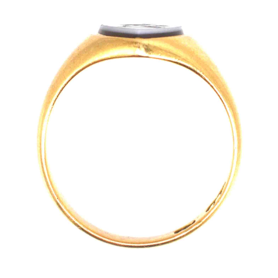Victorian 18ct gold signet ring featuring a shield-shaped carnelian intaglio with stork and anchor design.