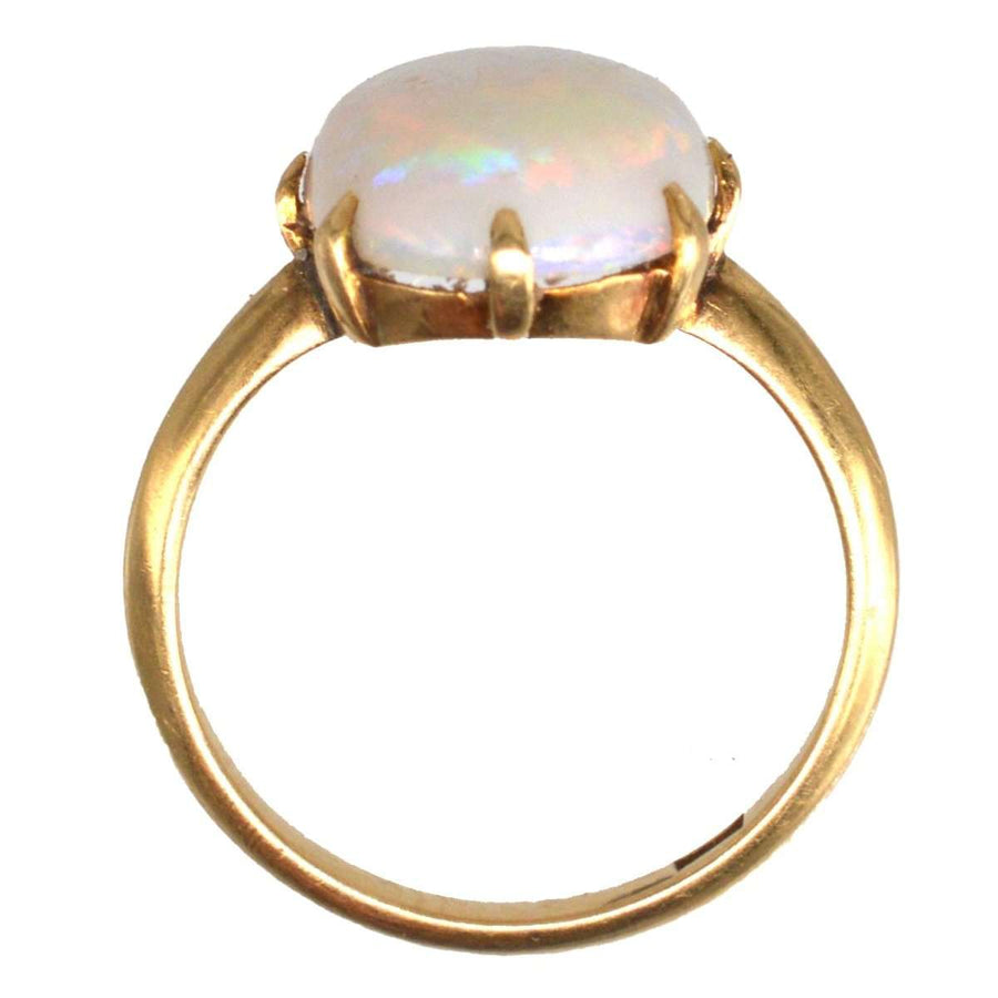Art Deco 18ct gold ring featuring a stunning white opal with vibrant red and kaleidoscopic color play.