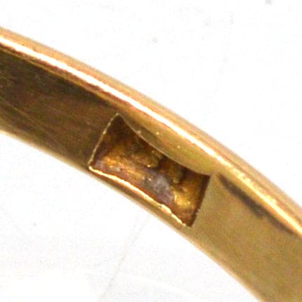 Close-up of the inner band of an Art Deco 18ct gold ring, highlighting the craftsmanship and opal setting.