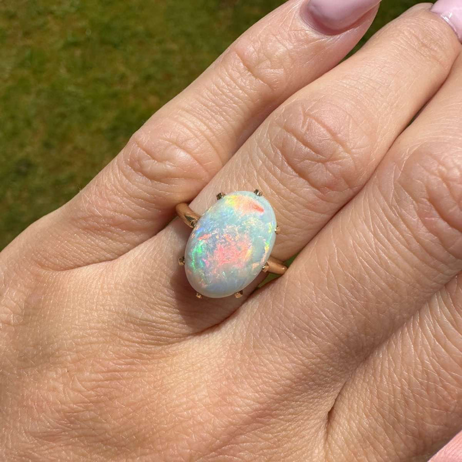 Stunning Art Deco 18ct gold opal ring featuring vivid red flashes and colorful play of light.