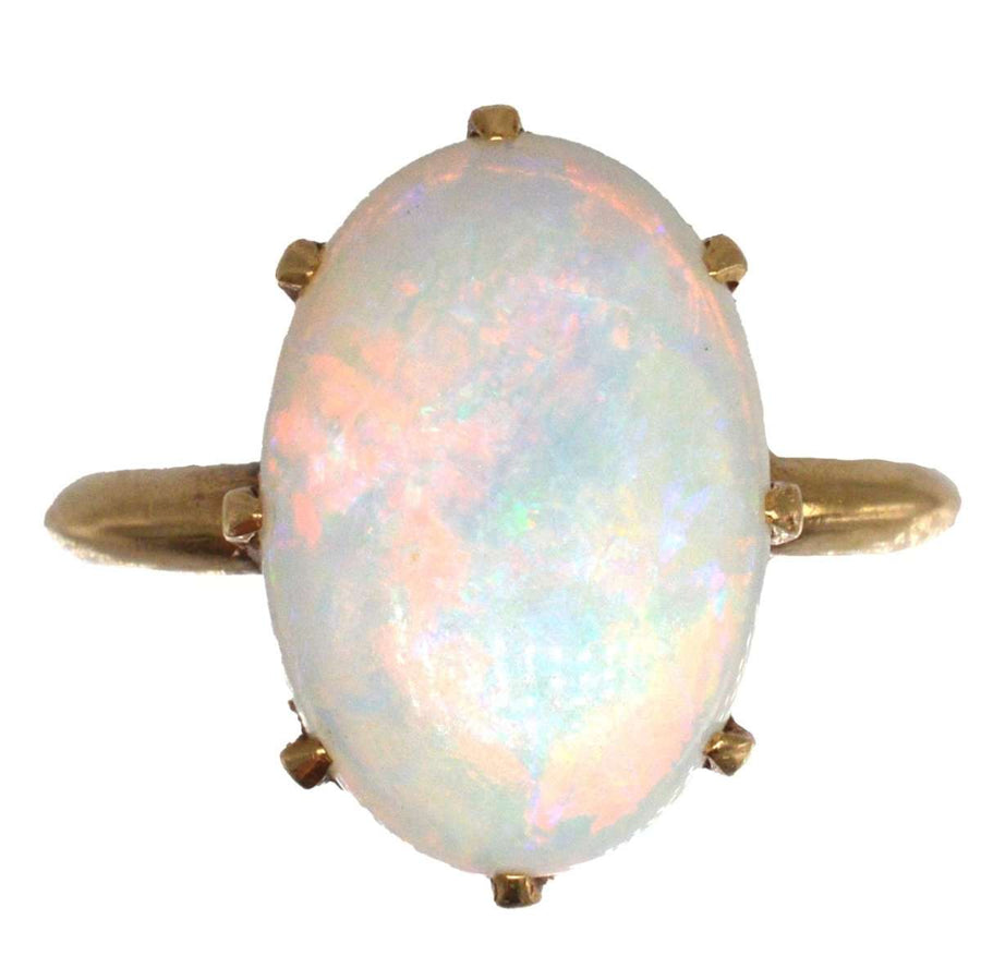 Art Deco 18ct gold ring featuring a stunning white opal with vibrant red, green, blue, and yellow flashes.