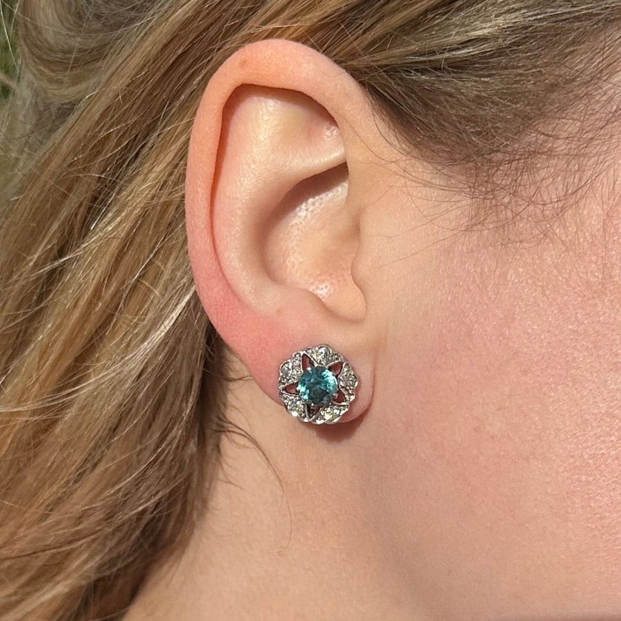 Art Deco 9ct white gold earrings featuring blue zircon and diamond clusters, showcasing a starburst design.