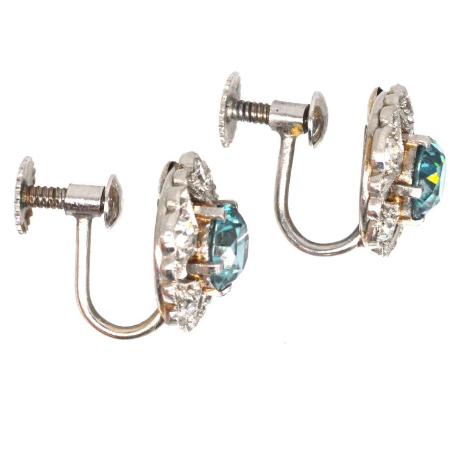 Art Deco 9ct white gold earrings featuring blue zircon and diamond clusters with intricate cut-out design.