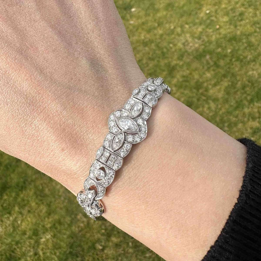 Art Deco Iridium Platinum diamond bracelet with geometric design, featuring 4 carats of sparkling diamonds, worn on wrist.