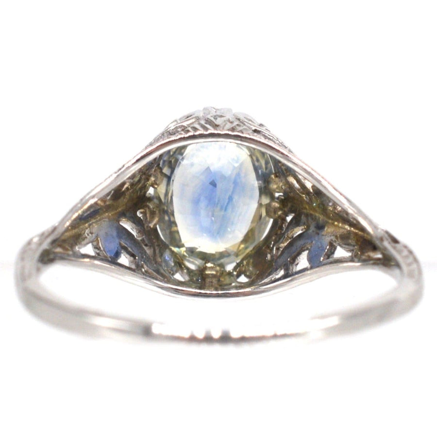 Belle Époque 18ct white gold ring featuring cornflower blue sapphire with intricate foliate design.