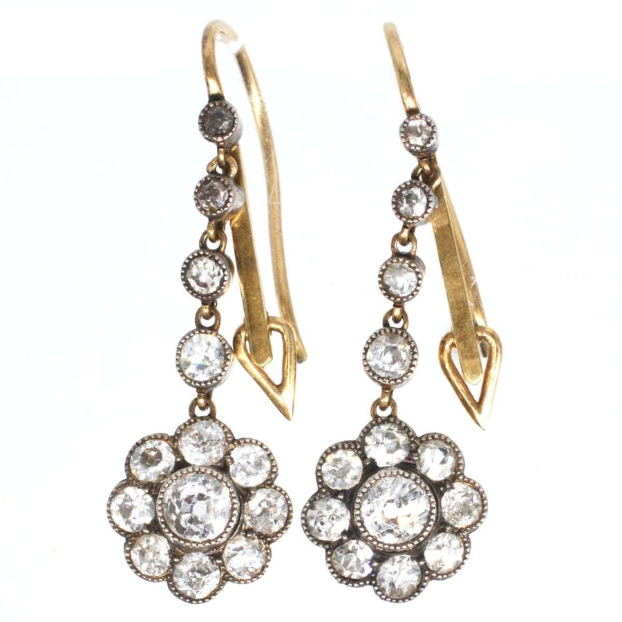 Edwardian 18ct gold and platinum diamond cluster drop earrings with milgrained detailing.