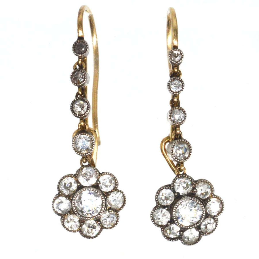 Edwardian 18ct gold and platinum diamond cluster drop earrings, featuring daisy clusters with graduated diamonds.