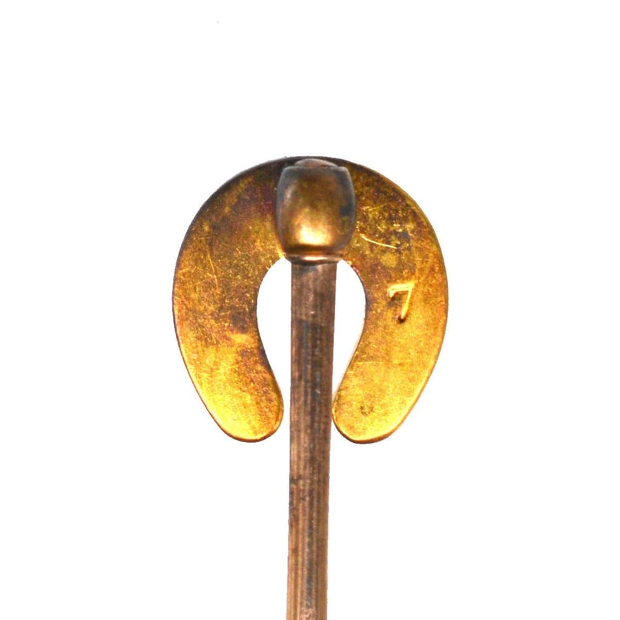 9ct gold horseshoe tie pin featuring pearl and coral, symbolizing good luck and protection from evil.