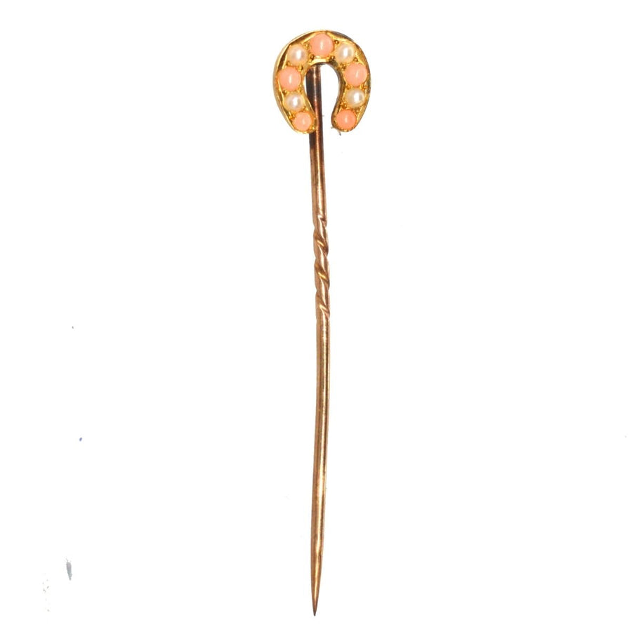 Edwardian small 9ct gold horseshoe tie pin with pearl and angel skin coral, symbolizing good luck.