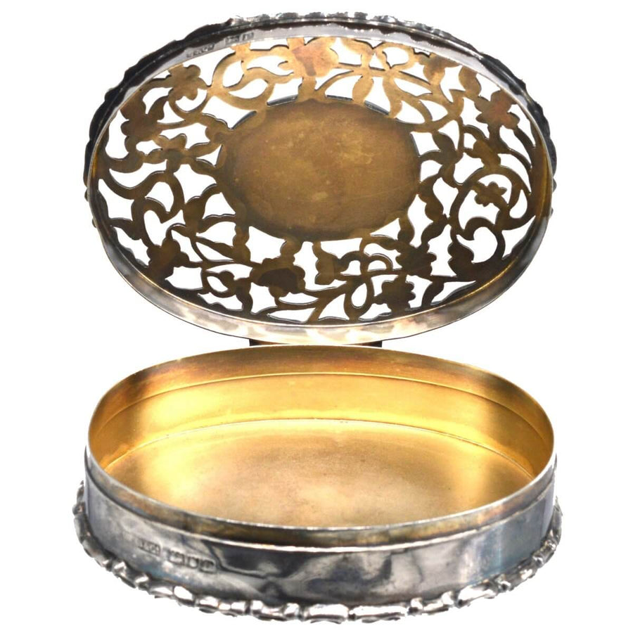 Edwardian sterling silver oval trinket box with intricate cut-card work, crafted in London, 1912.