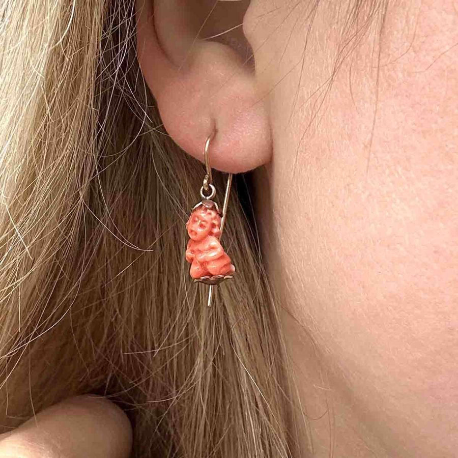 Regency-era Georgian 12ct gold earrings featuring coral Cupid charm, symbolizing love and protection.