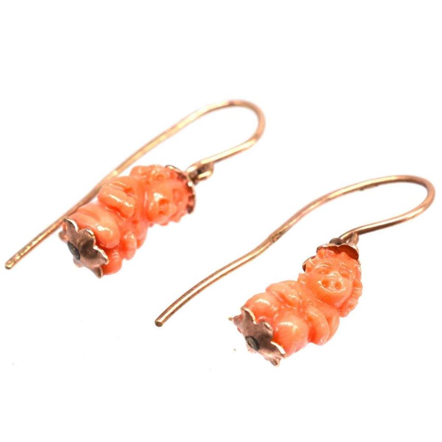 Georgian 12ct gold coral Cupid earrings, featuring carved coral cupids embodying love and protection.
