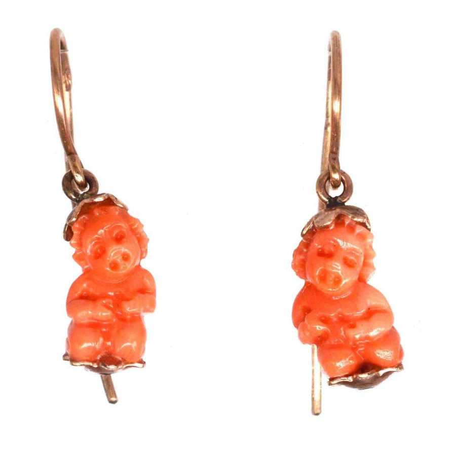 Georgian gold earrings featuring carved coral cupids, symbolizing love and romance, from the 1820s-1840s