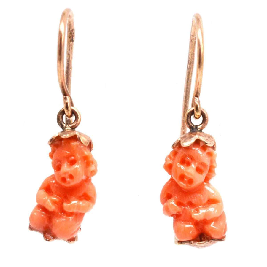 Georgian 12ct gold coral cupid earrings, featuring intricately carved coral cupids in a Regency design.