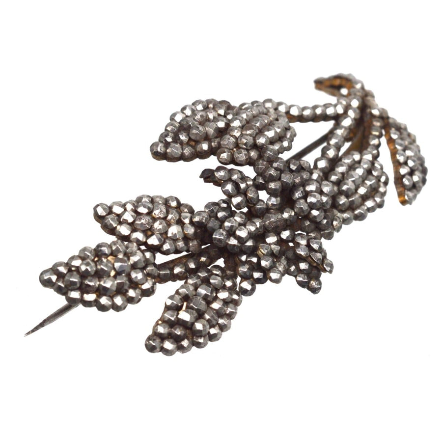 Georgian cut steel floral brooch with intricate details and sparkling riveted steel studs.