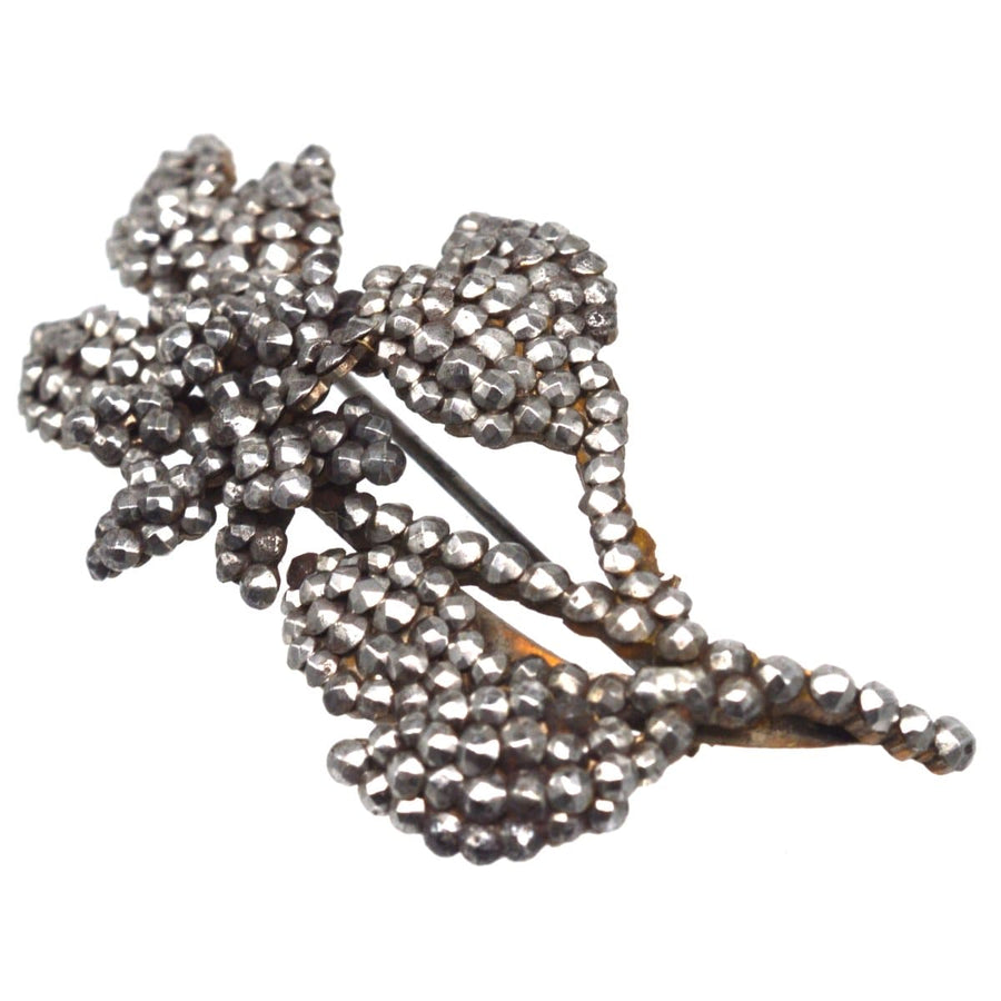 Georgian cut steel floral brooch featuring intricate detailing and sparkling riveted steel studs.