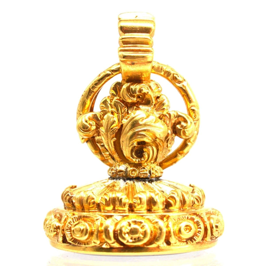 Intricately designed golden Georgian seal featuring ornate floral details and a circular handle.