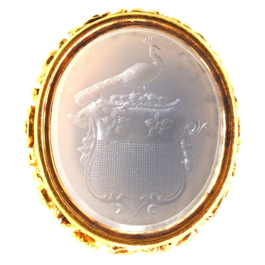 Large Georgian seal featuring a peacock crest and family coat of arms in white chalcedony, ornate gold setting.