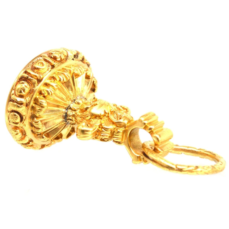 Gold Georgian seal with intricate embossed details and a peacock crest design.