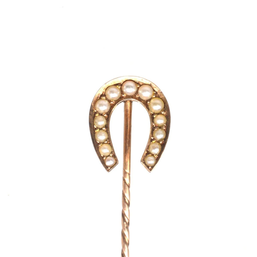 Late Victorian 9ct gold horseshoe tie pin adorned with creamy seed pearls, symbolizing good luck and protection.