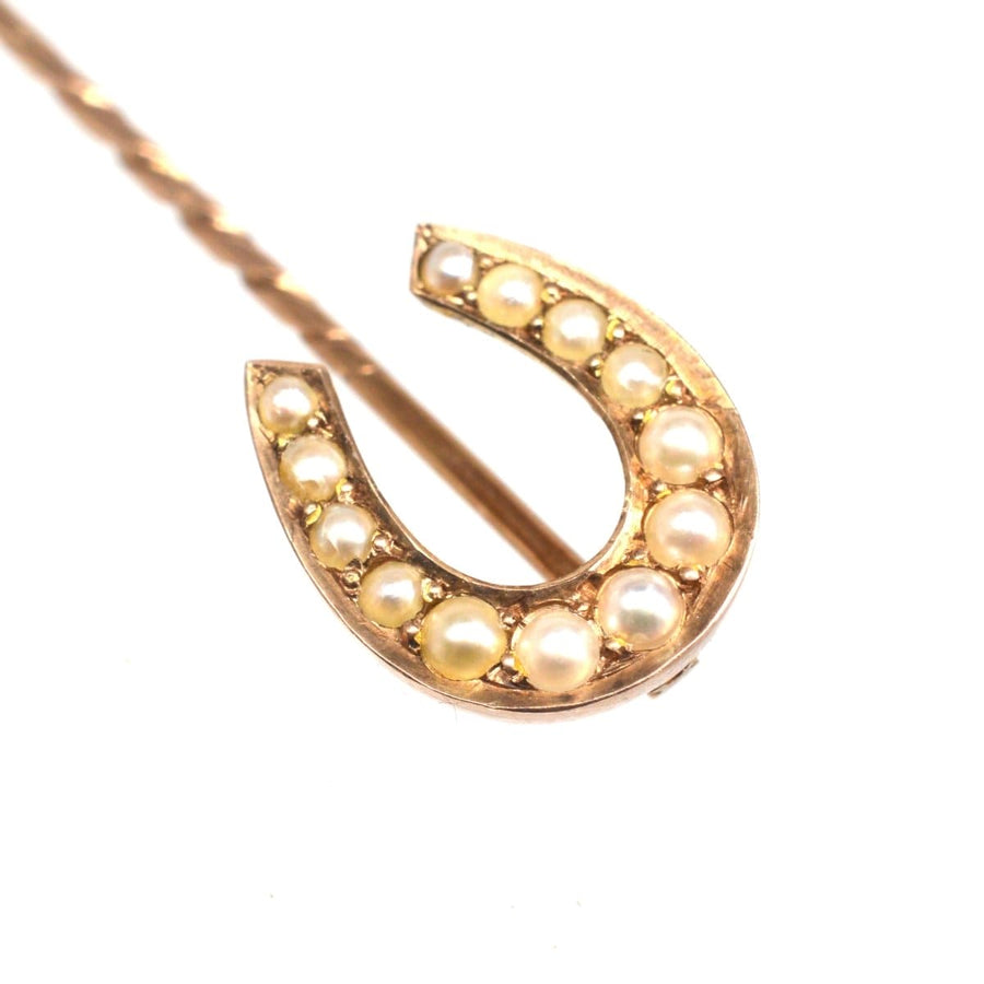Late Victorian 9ct gold horseshoe tie pin adorned with creamy white seed pearls, symbolizing good luck.