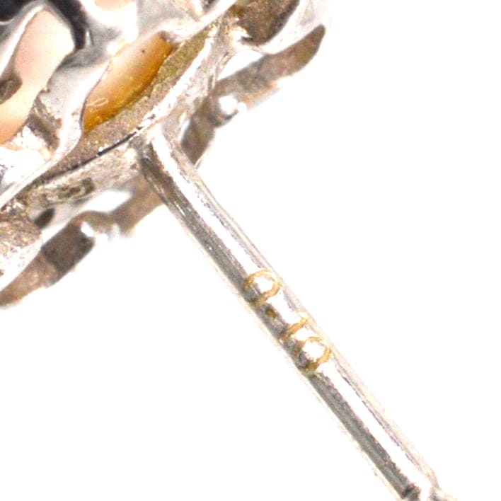 Close-up of a 9ct white gold earring post showcasing intricate detailing and hallmark.