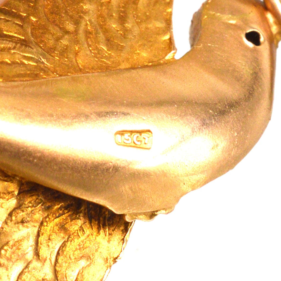 Close-up of Victorian 15ct gold swallow bird pendant, showing intricate details and hallmark.