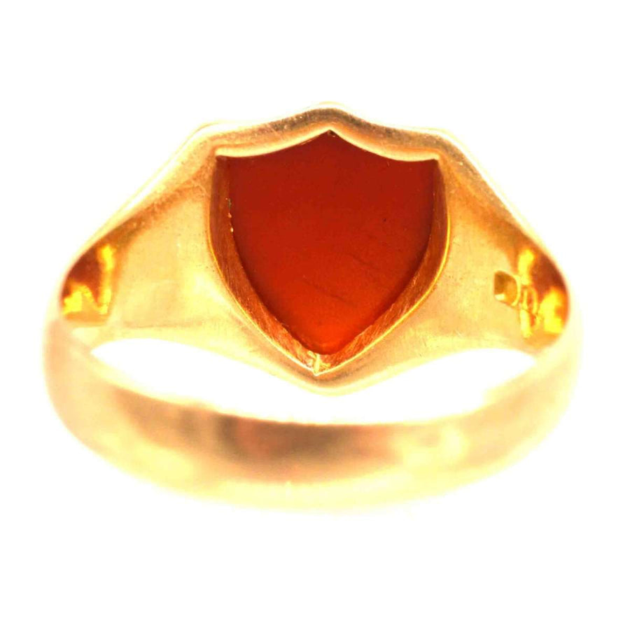 Victorian 18ct gold signet ring featuring a shield-shaped carnelian stone, showcasing elegant craftsmanship from the 1890s.