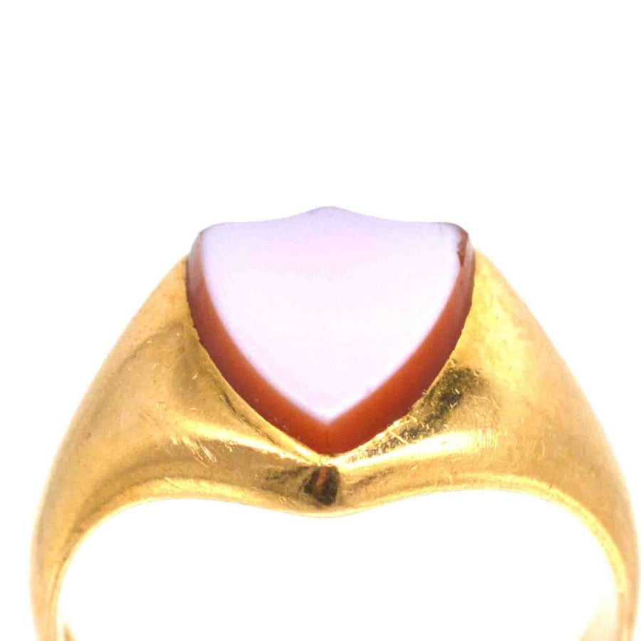 Victorian 18ct gold signet ring featuring a shield-shaped carnelian stone, dating to the 1890s.