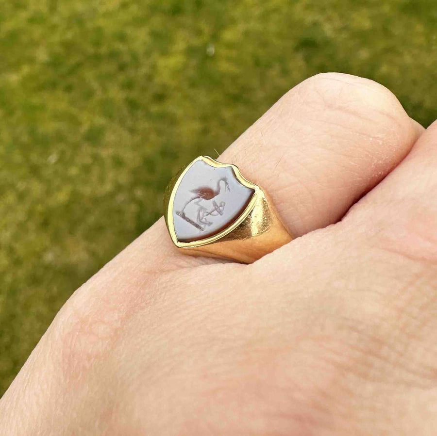 Victorian 18ct gold signet ring with carnelian intaglio stork and anchor design, showcasing elegance and history.