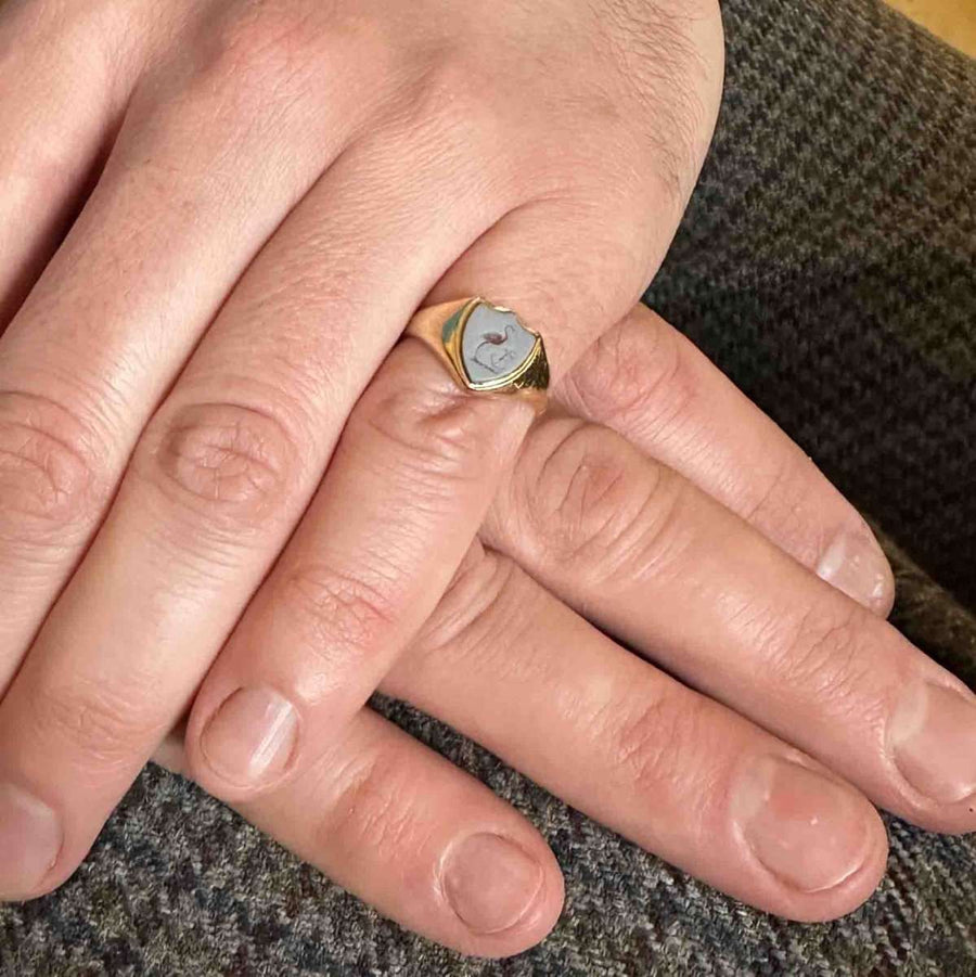 Victorian 18ct gold signet ring with carnelian stork and anchor intaglio on a hand