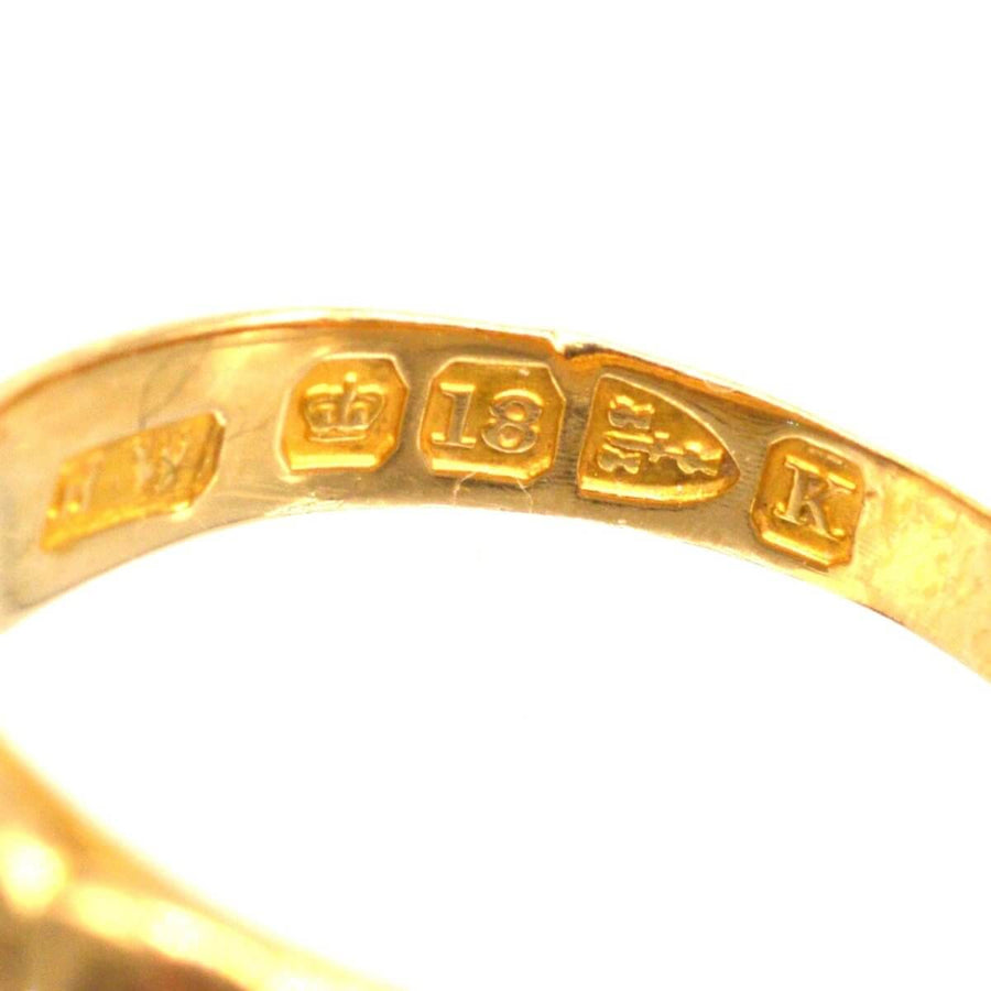 Hallmark details of a Victorian 18ct gold band keeper ring, including maker's mark and purity stamp.