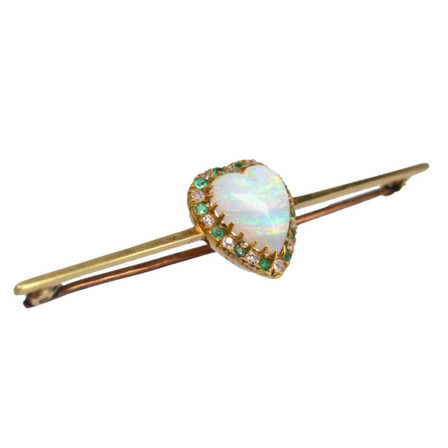 Victorian 18ct gold bar brooch featuring heart-shaped opal surrounded by diamonds and emeralds.