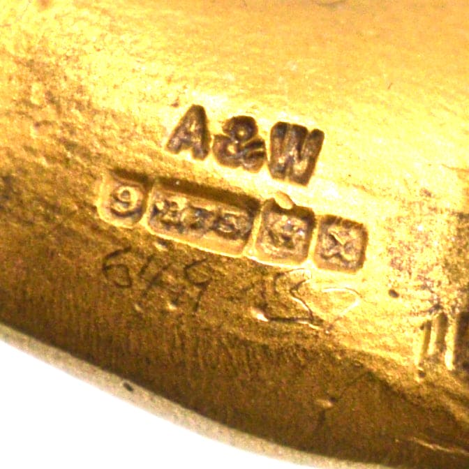 Hallmark details of 9ct gold brooch by Alabaster & Wilson, featuring A&W mark and 1972 certification.