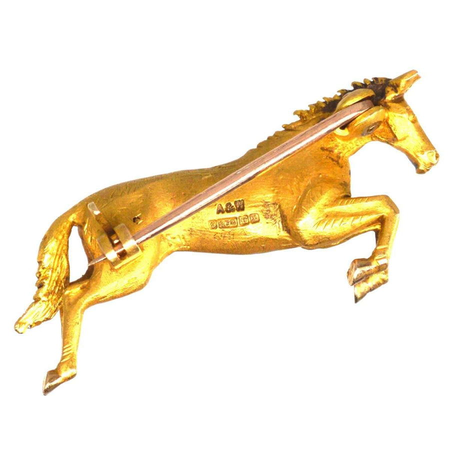 Vintage 9ct gold horse brooch by Alabaster & Wilson, showcasing an elegant horse mid-jump, hallmarked 1972.