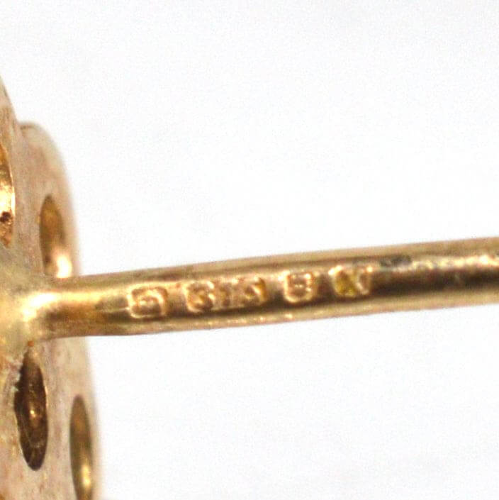 Close-up of hallmark on vintage 9ct gold opal cluster stud earrings, showcasing 1984 London mark.