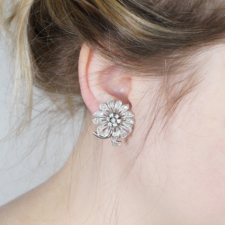 1940s 18ct white gold diamond flower cluster earrings worn, showcasing dramatic vintage design with sparkling diamonds.