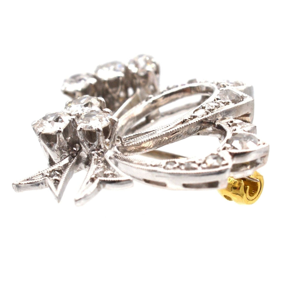 1940s 18ct white gold diamond bow motif brooch showcasing old and rose cut diamonds.