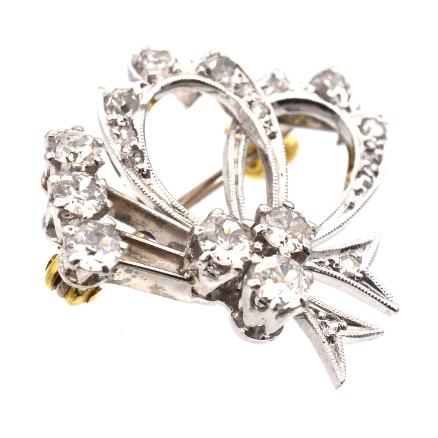 1940s 18ct white gold diamond bow motif brooch with one carat of mixed old and rose cut diamonds.