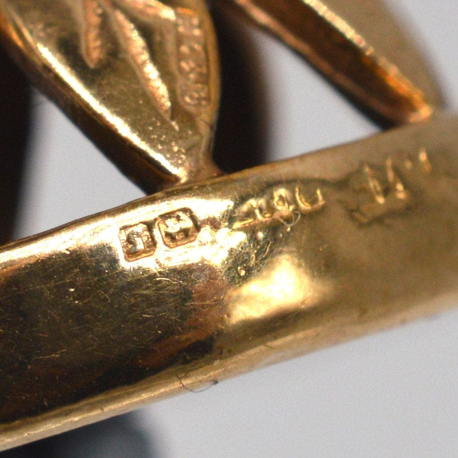 Close-up of the hallmark on a 9ct gold pendant from 1942, showcasing its authenticity and craftsmanship.