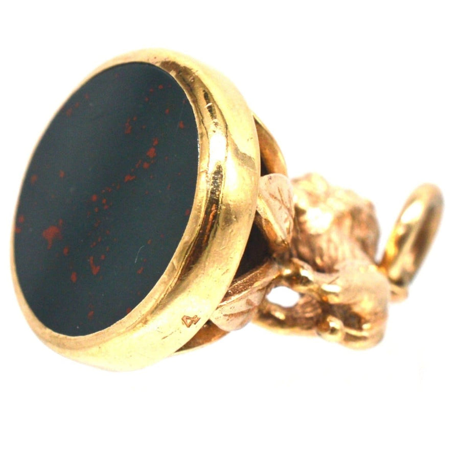 1940's 9ct gold pendant featuring a lion on a wreath with a bloodstone seal, fully hallmarked and vintage.