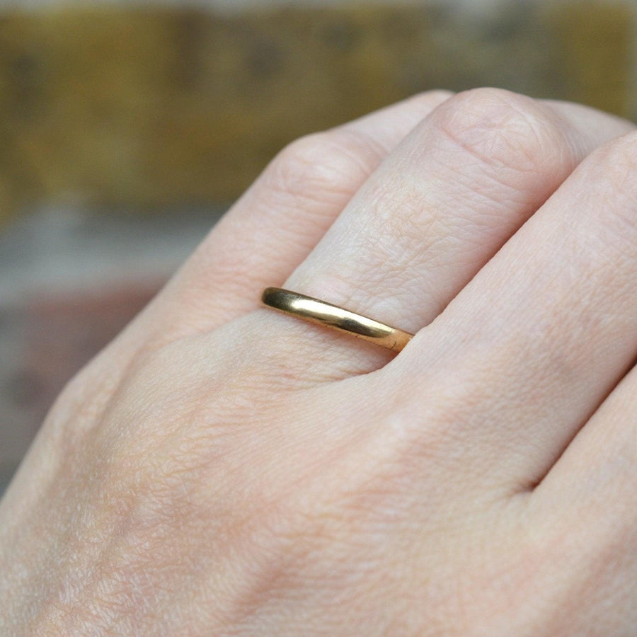 1940s 9ct gold wedding ring on hand showcasing its thin shank and comfortable design.
